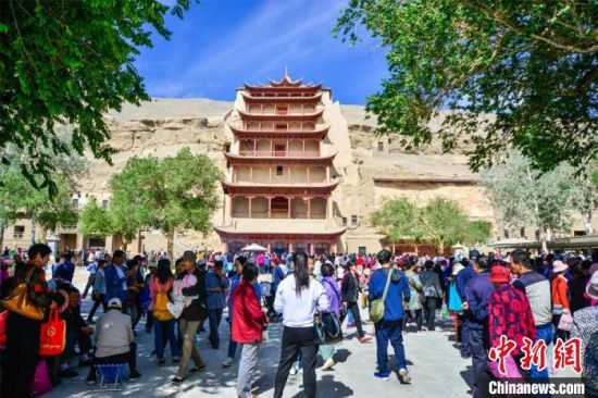 中國農(nóng)歷四月初八，敦煌民眾傳承歷史習(xí)俗，前往莫高窟燒香禮佛、祈福。(資料圖) 王斌銀 攝