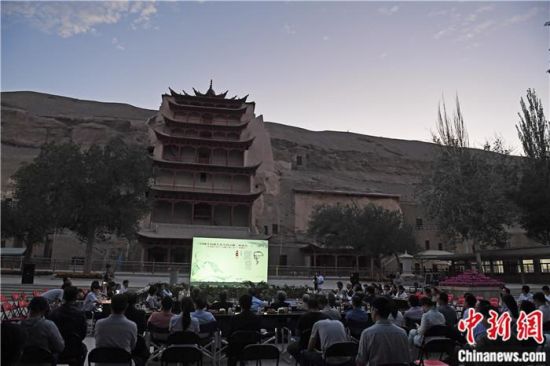 2018年8月，在敦煌莫高窟標(biāo)志性建筑“九層樓”前，《回顧平山郁夫先生的貢獻(xiàn)》座談會舉行。來自中日兩國的專家、學(xué)者共同懷念這位情系敦煌數(shù)十載的繪畫巨匠、中日友好的文化使者、世界文化遺產(chǎn)的守護(hù)者。中新社記者 楊艷敏 攝