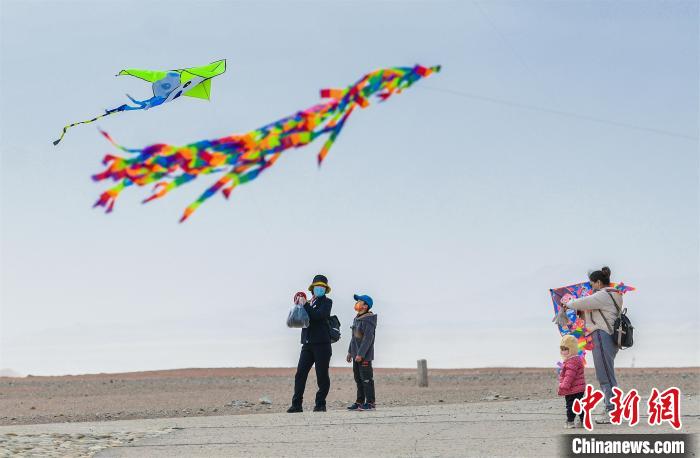 圖為孩童在父母的陪伴下放風(fēng)箏。　王斌銀 攝