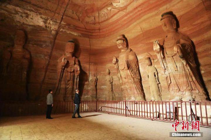 7月15日，游人參觀甘肅省平?jīng)鍪袥艽h百里石窟長廊中的南石窟寺1號窟。百里石窟長廊位于涇川縣境內(nèi)，由512個石窟、5眼窟中石井組成，現(xiàn)存王母宮石窟、鳳凰山石窟、南石窟寺、丈八寺石窟、羅漢洞石窟、太山寺石窟等規(guī)模較大的石窟群，還有數(shù)量眾多的小石窟群。南石窟寺開鑿于北魏永平三年，其中1號窟屬于大型七佛窟，七佛高達6米。中新社記者 李亞龍 攝